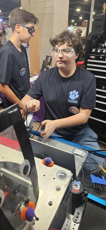 One MHS robotics working on foxing robot at state competition