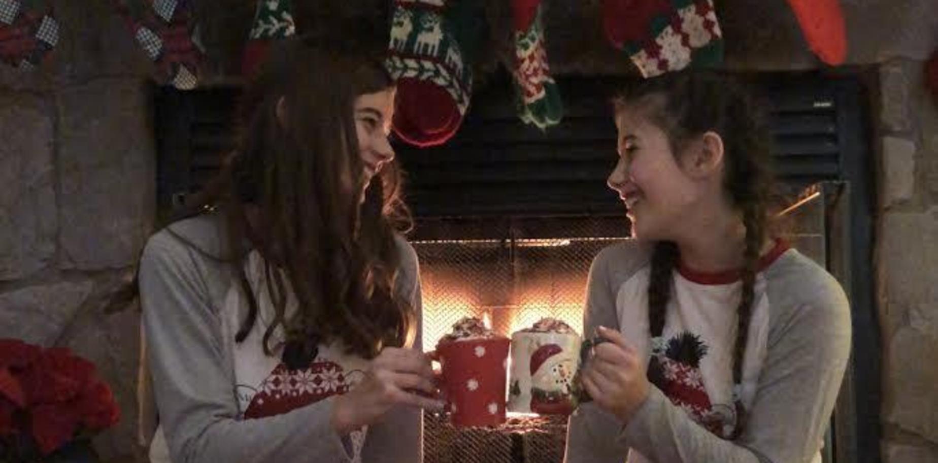 pic of two girls in front of a fireplace