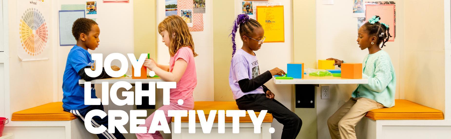 Four children engaged in creative activities in a bright classroom.