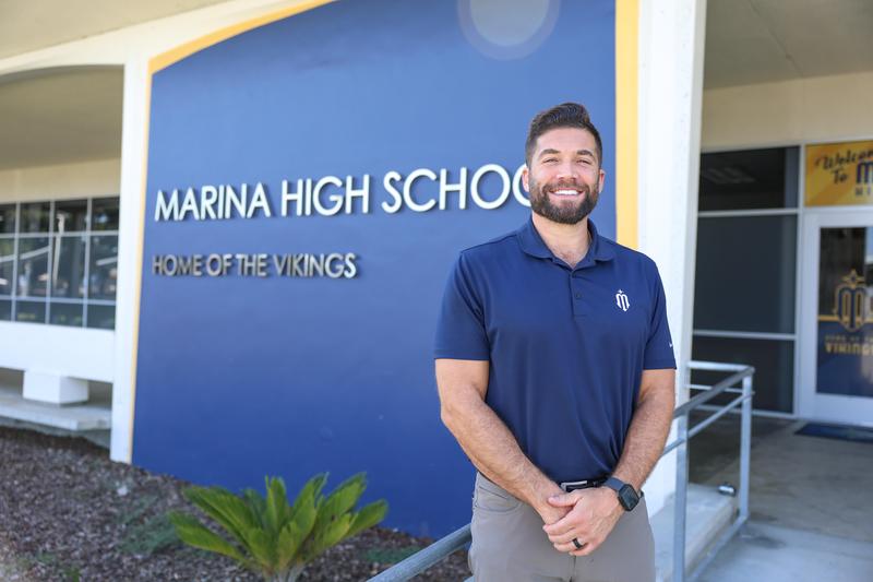 Jonathan Goffman smiles in front of Marina High School