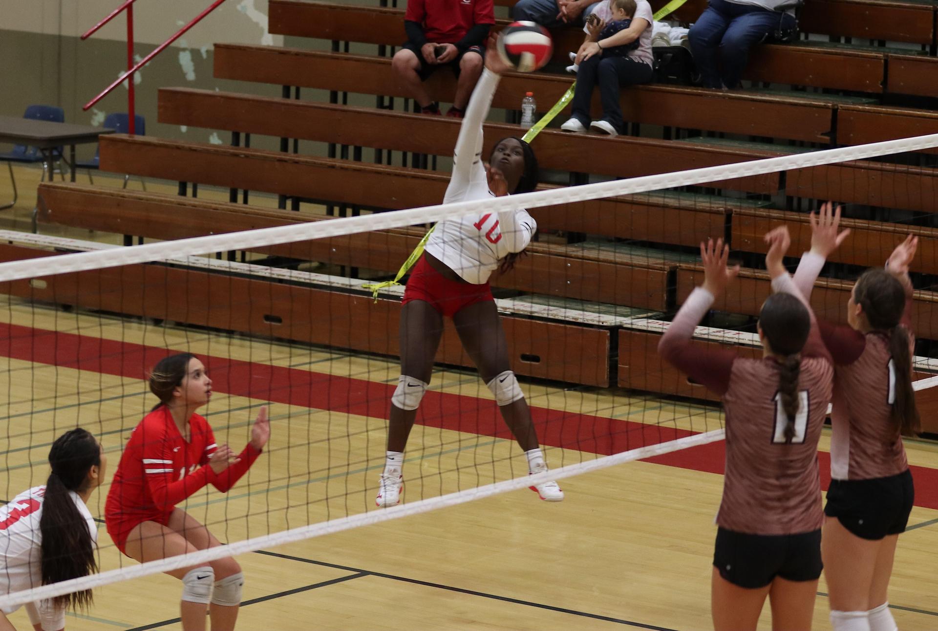 varsity volleyball players in action against Fresno Christian