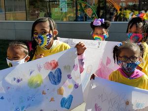 Image shows scholars holding up BLM posters