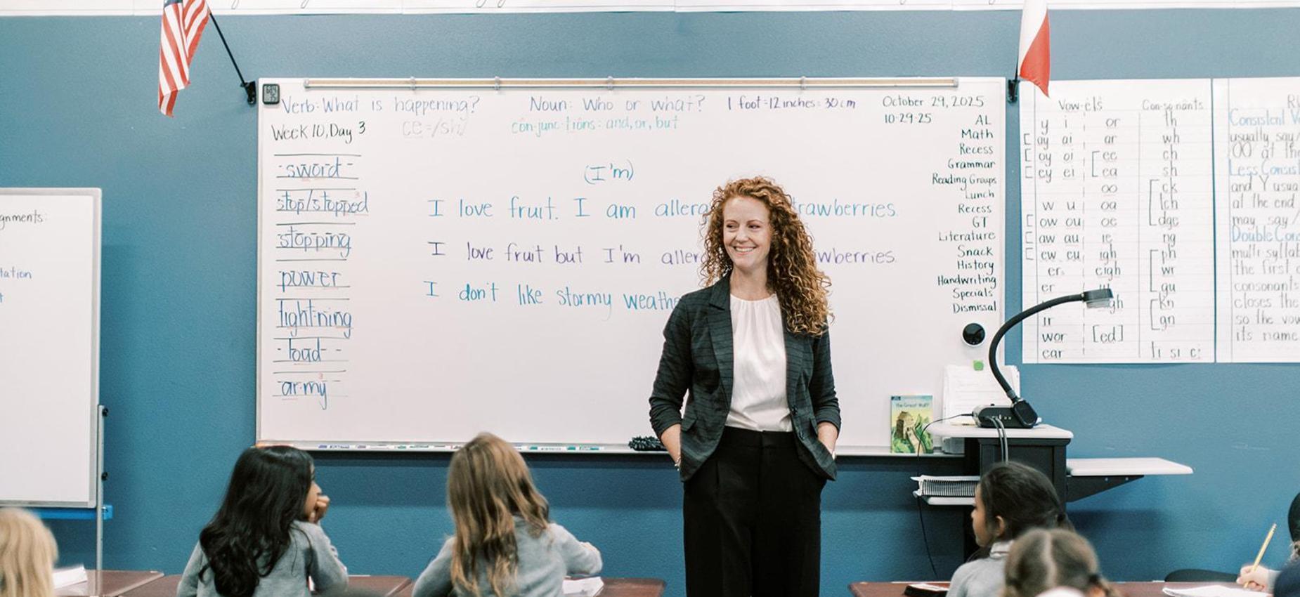 Teacher leads a lesson at the front of the classroom