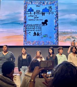 Students stand in front of art