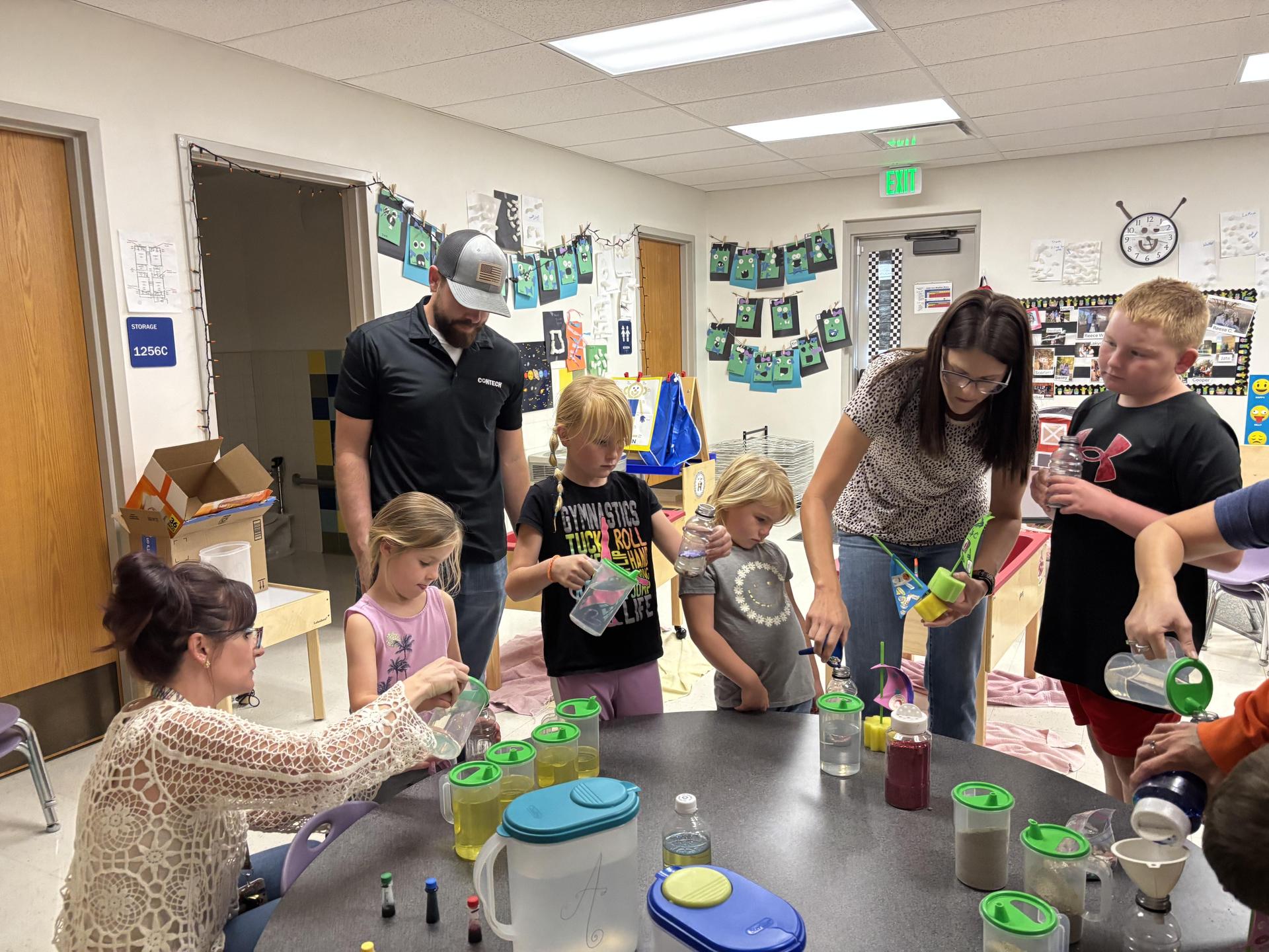 Parents and children making sensory bottles during steam night