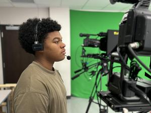 MHS media student running a camera for a broadcast