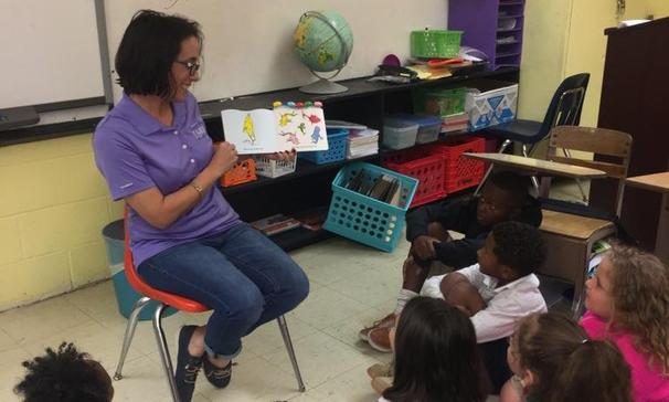 Mrs. Monique Smith sharing One Fish Two Fish Red Fish Blue Fish with her class in Jamaican Patois Style for International Literacy Day.