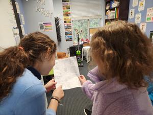 MSG girls go over a submission to the newspaper