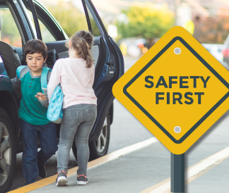 Safety first sign with two elementary students exiting a car