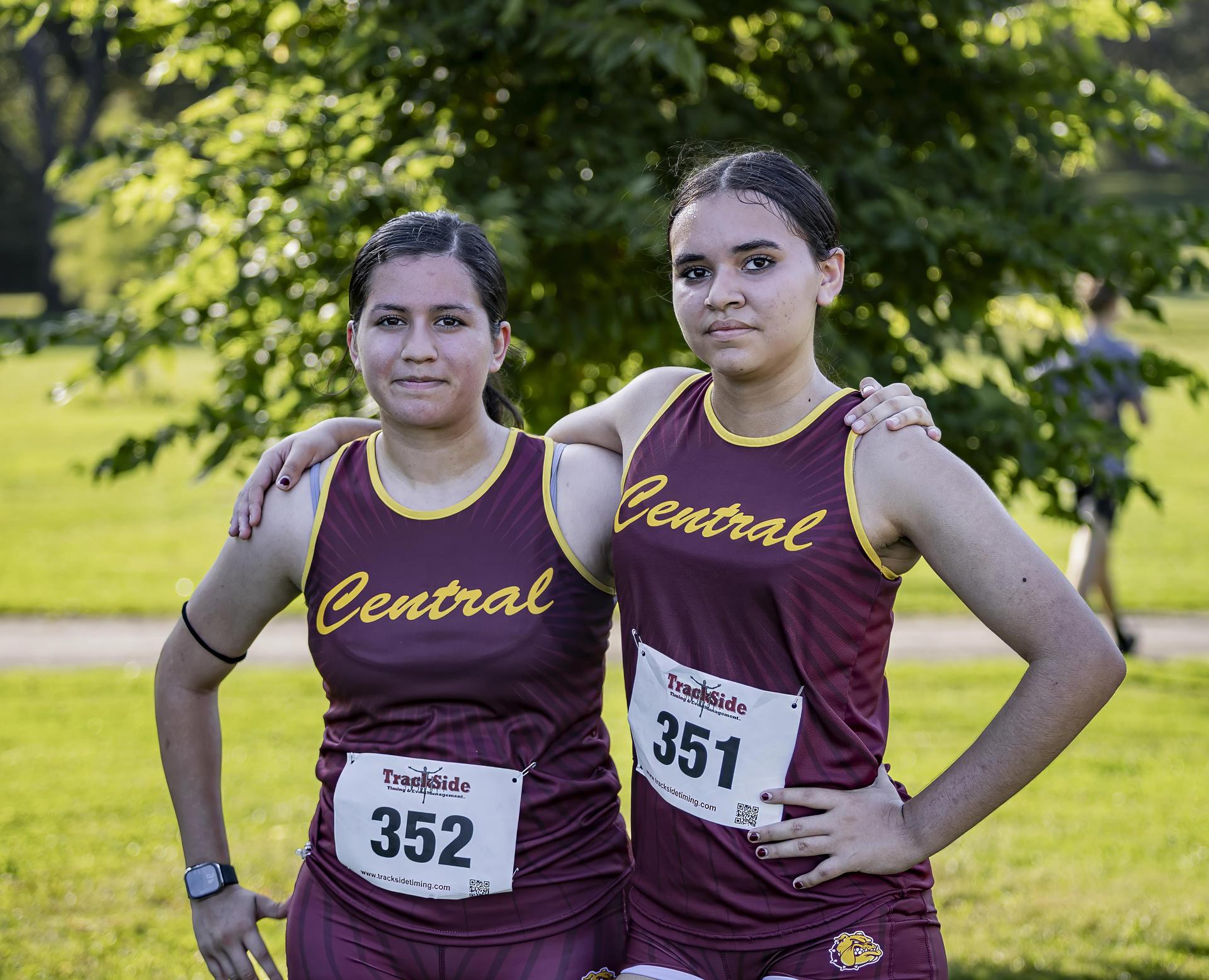Two athletes smiling for a photo