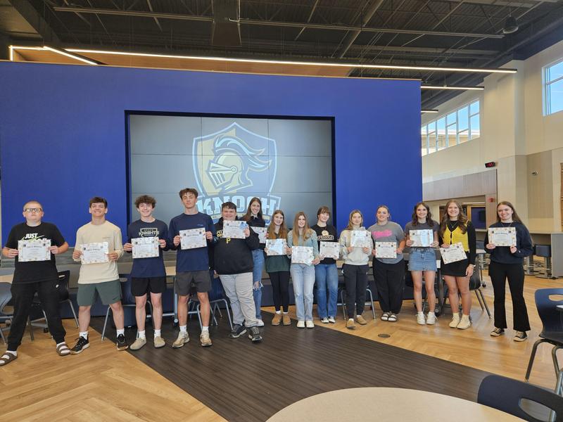 winners standing in line holding certificate in front of knoch logo