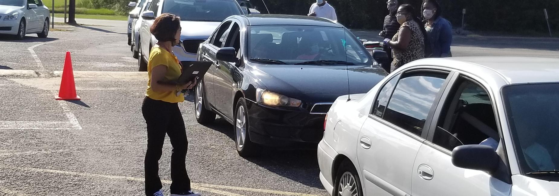 DS Johnson Elementary School Teachers and Staff are standing outside the school greeting DSJ Parents and Students as they drove pass during the first time DSJ