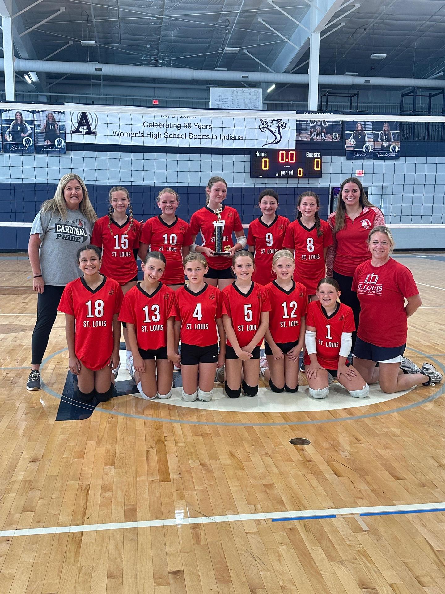 St. Louis 7th grade volleyball team posing with trophy