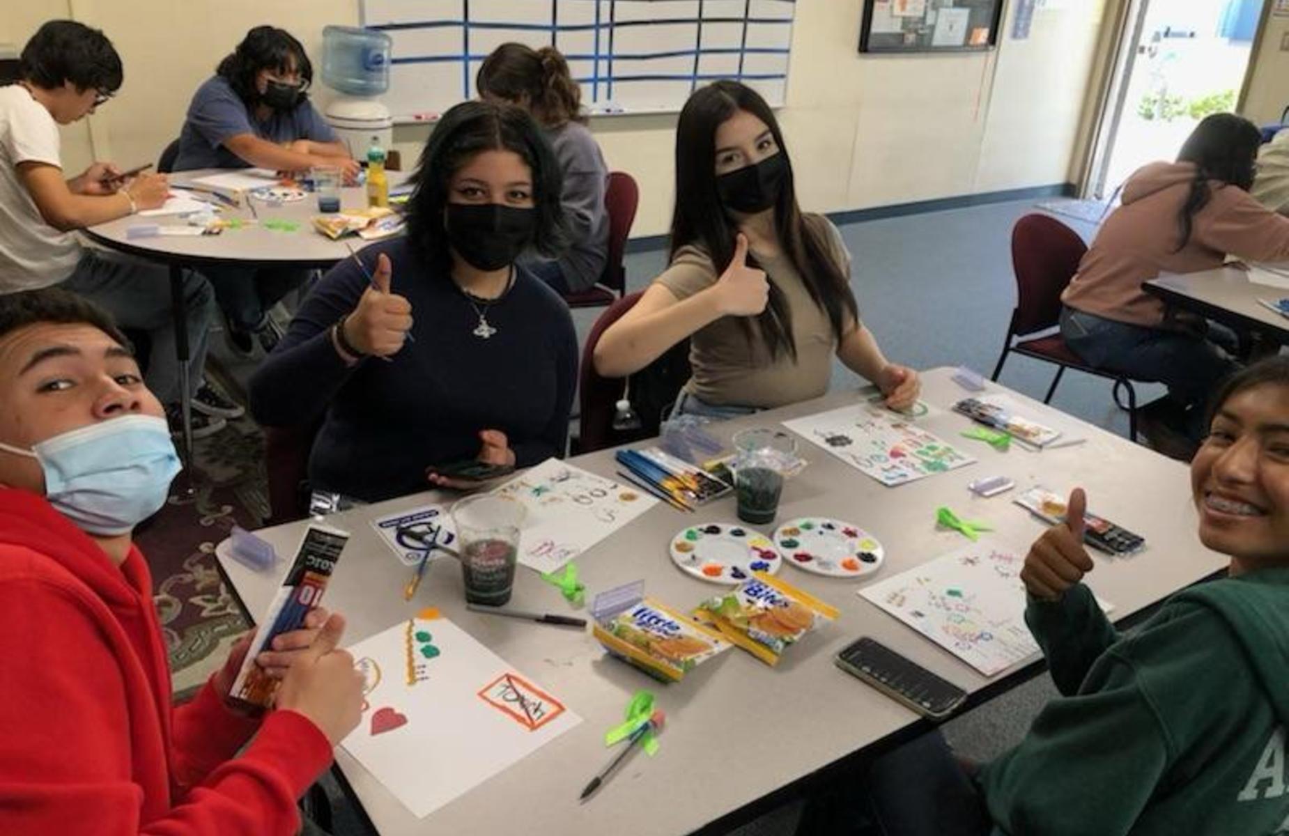 Students with thumbs up during Mental Health Awareness Month