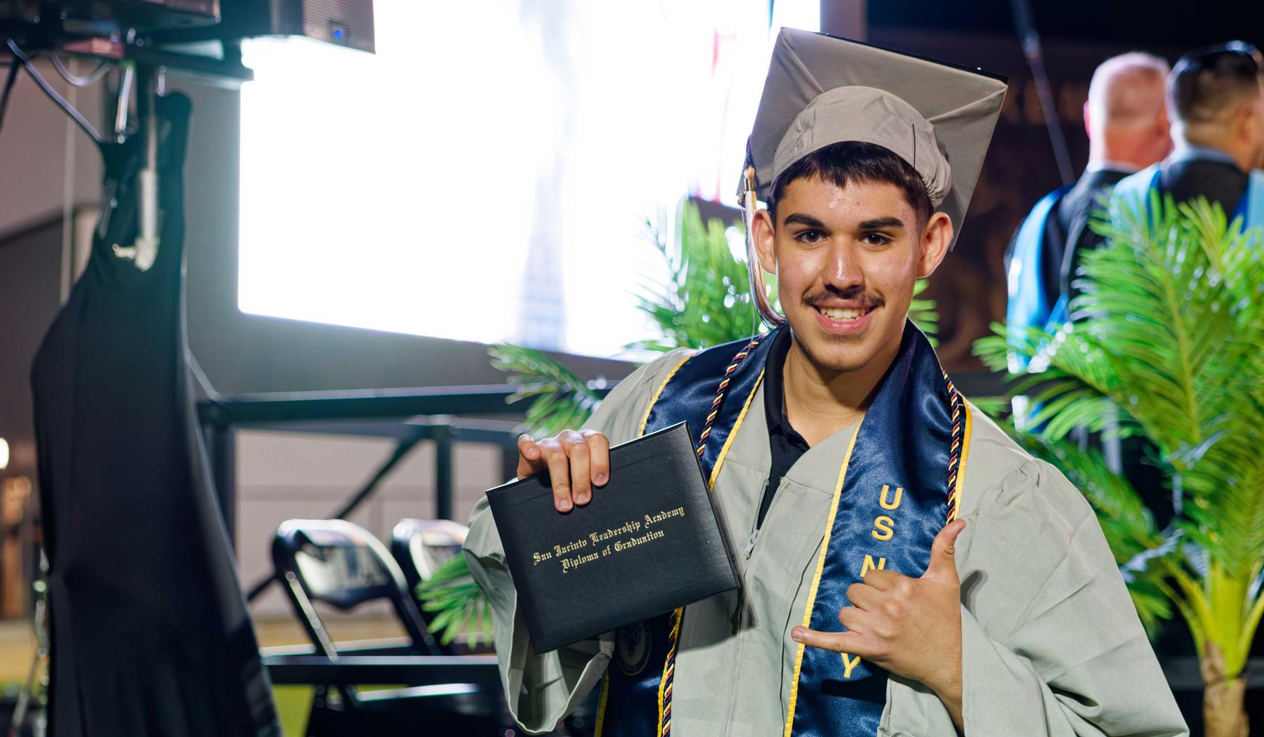 SJLA Graduate showing diploma