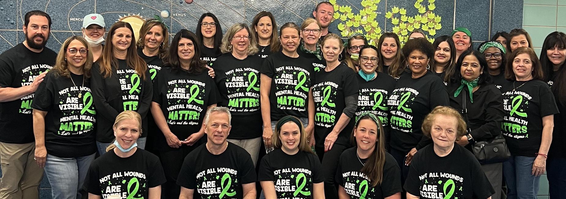 group of teachers in mental health awareness shirts