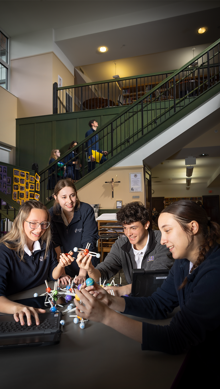 OLSH students working together in the library