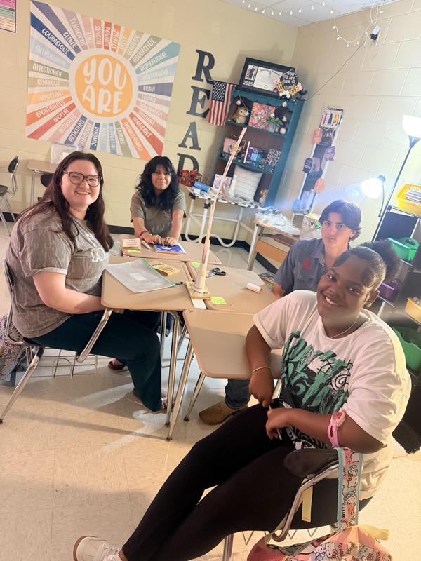 smiling students show off finished project