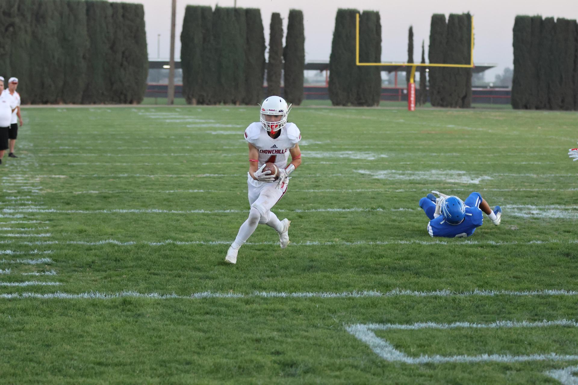 Junior Varsity football players in action against Caruthers
