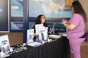 Staff member gives information to a parent