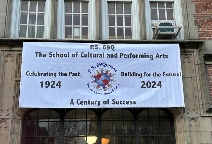 Front of school building with a signing celebrating 100 years.