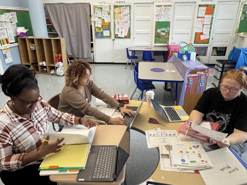 3 staff sitting in a group