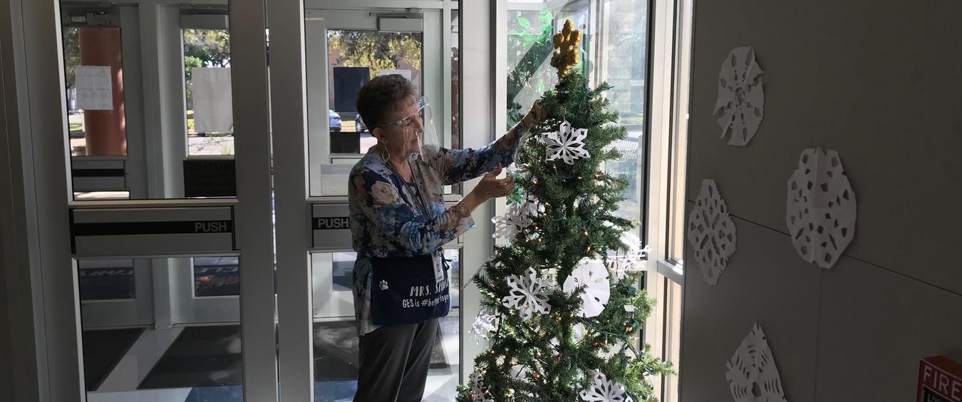 Smiga putting snowflakes on tree