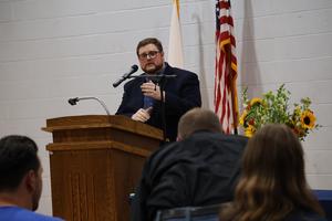 Justin Lawrence, Adult Education Coordinator, at the podium