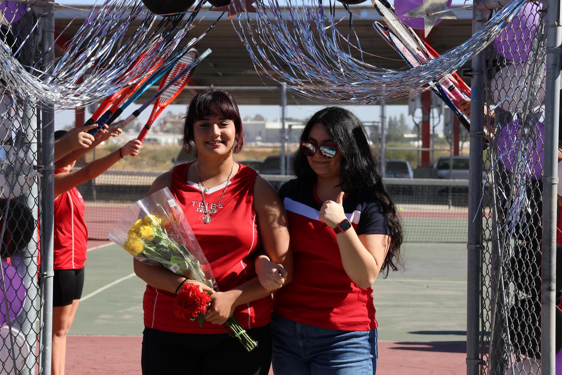 tennis players, family, and staff celebrating senior night