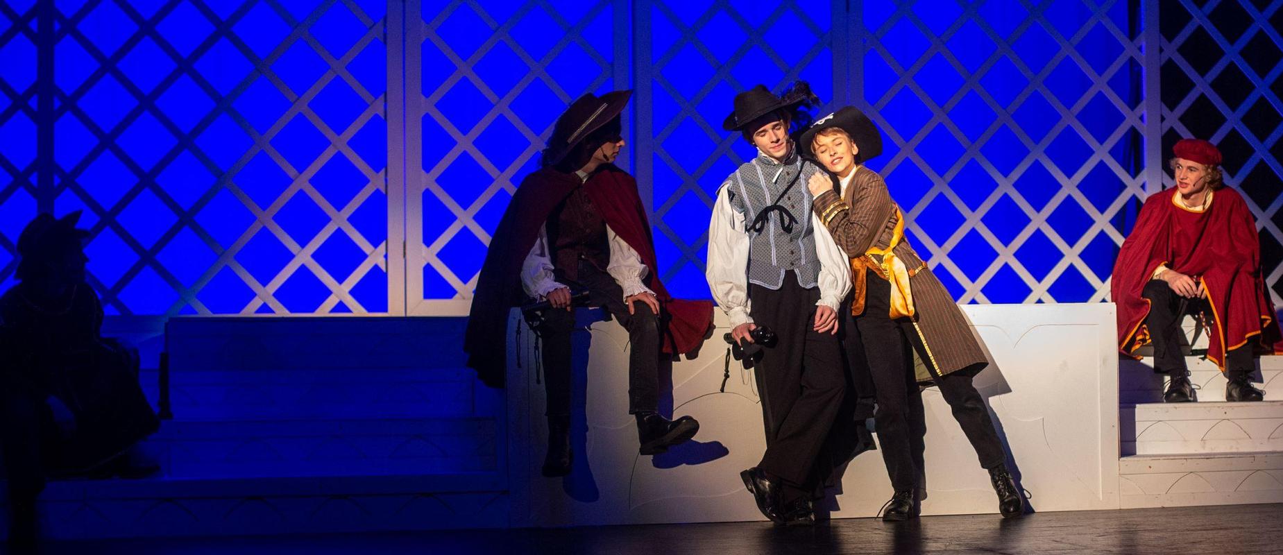 Romeo and Juliet performers act on stage in medieval garb