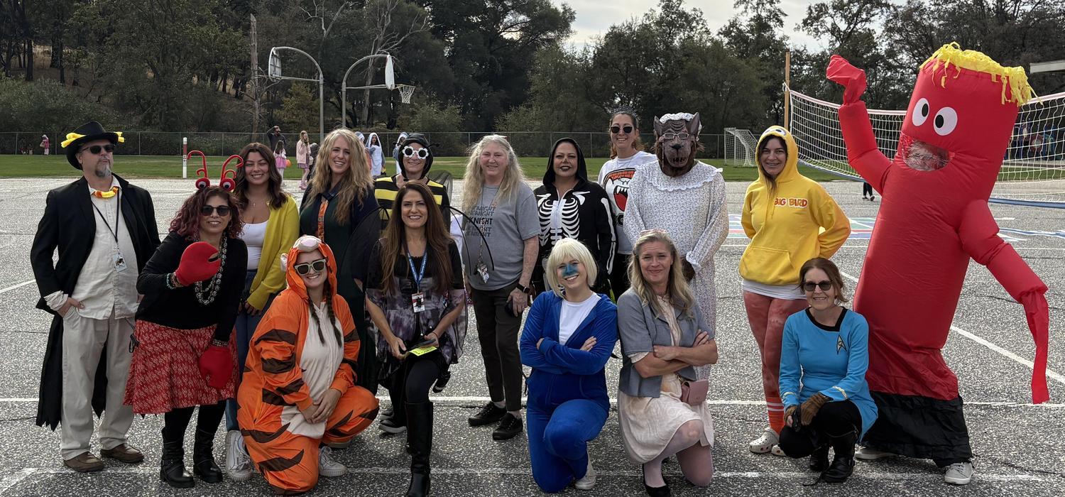 Staff pose in Halloween costumes on the blacktop