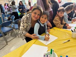 A kindergarten girl poses with her grandmother.