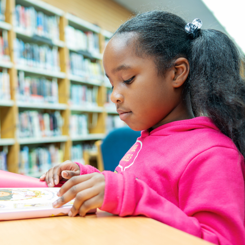 girl at desk in library