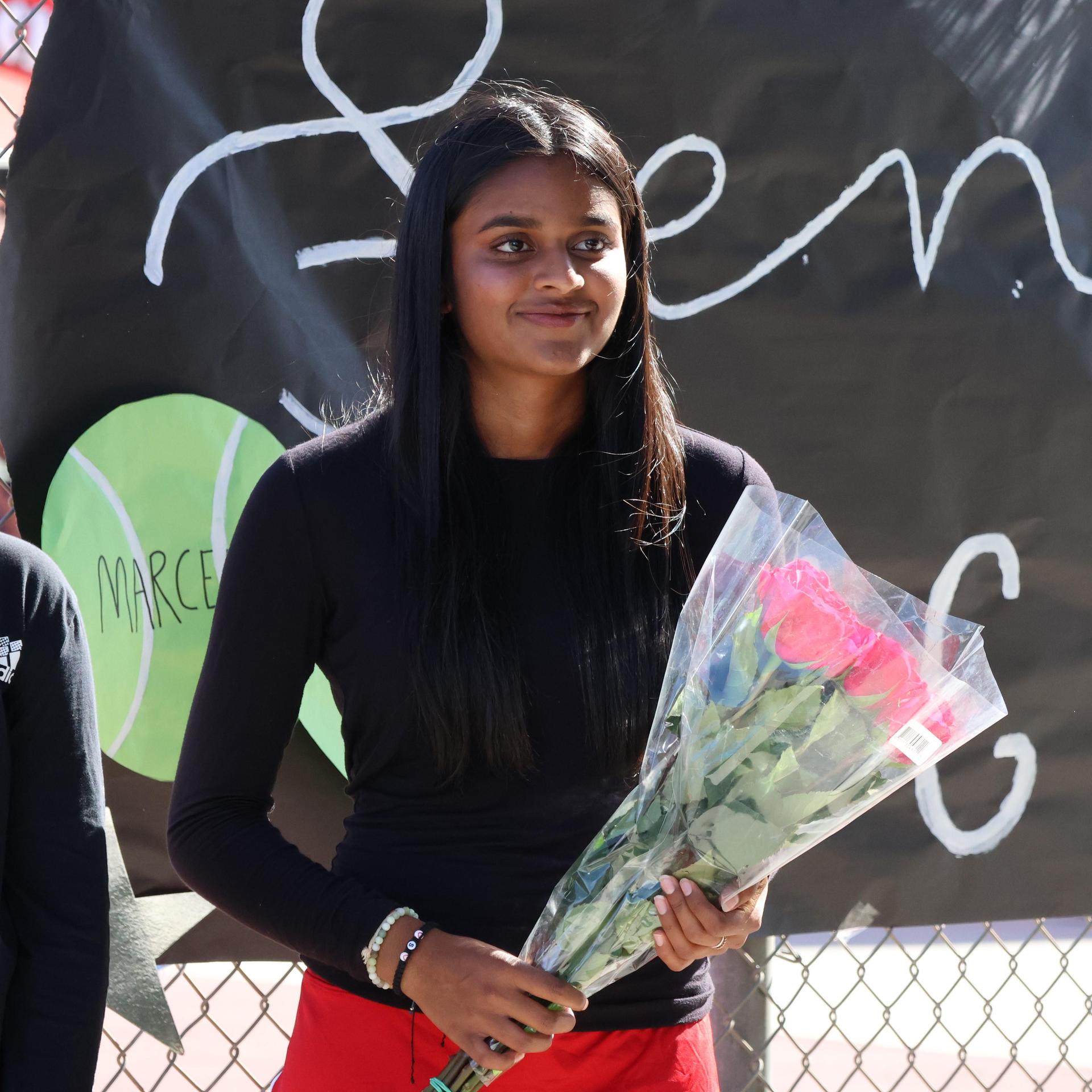 tennis players, family, and staff celebrating senior night