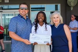 Student receives her check from foundation members