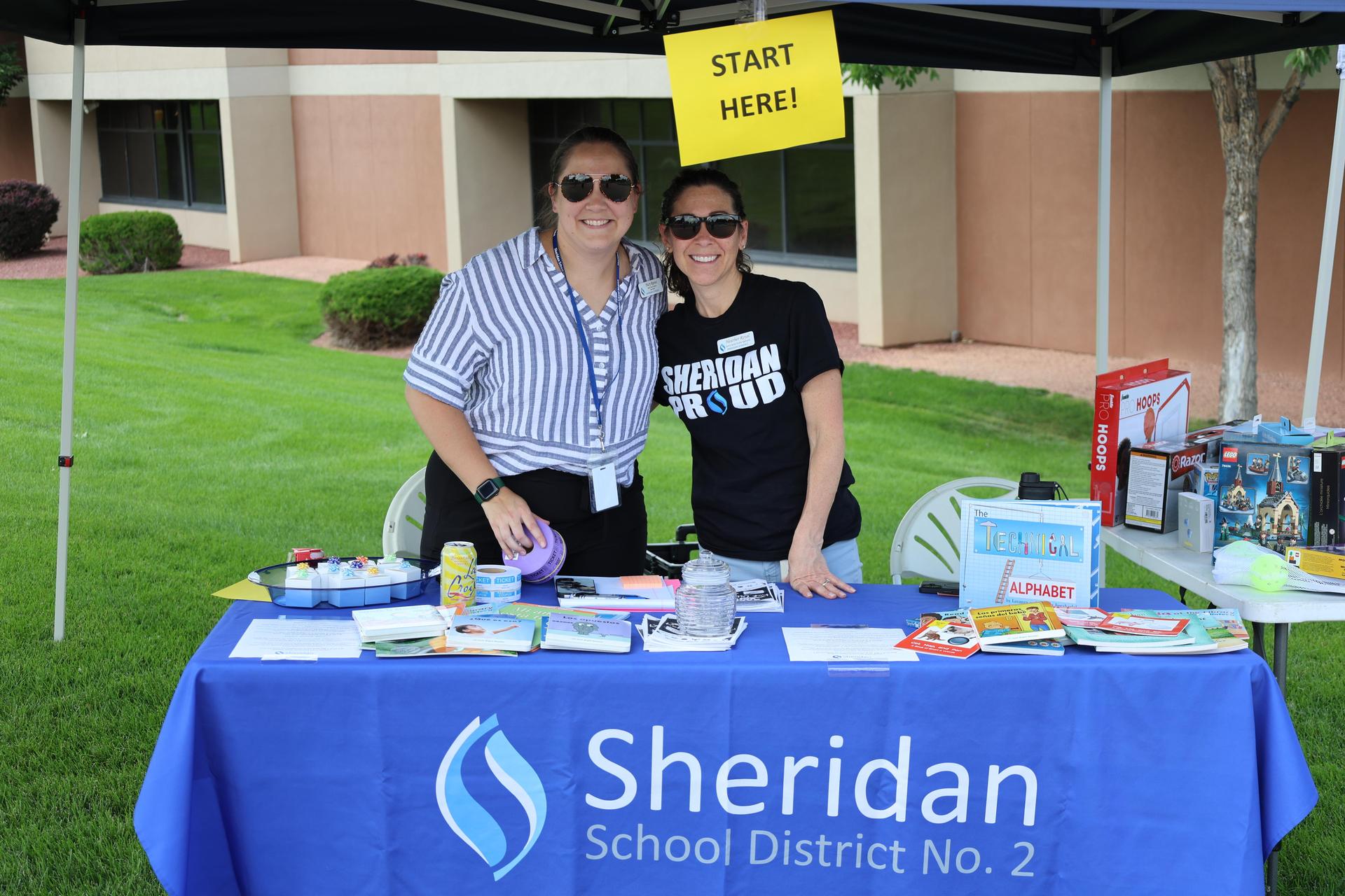 women smiling under tent