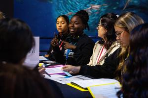 Students discuss around a table