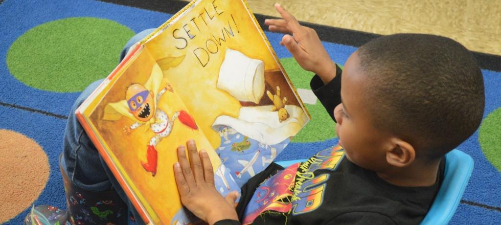 boy focuses attention on book