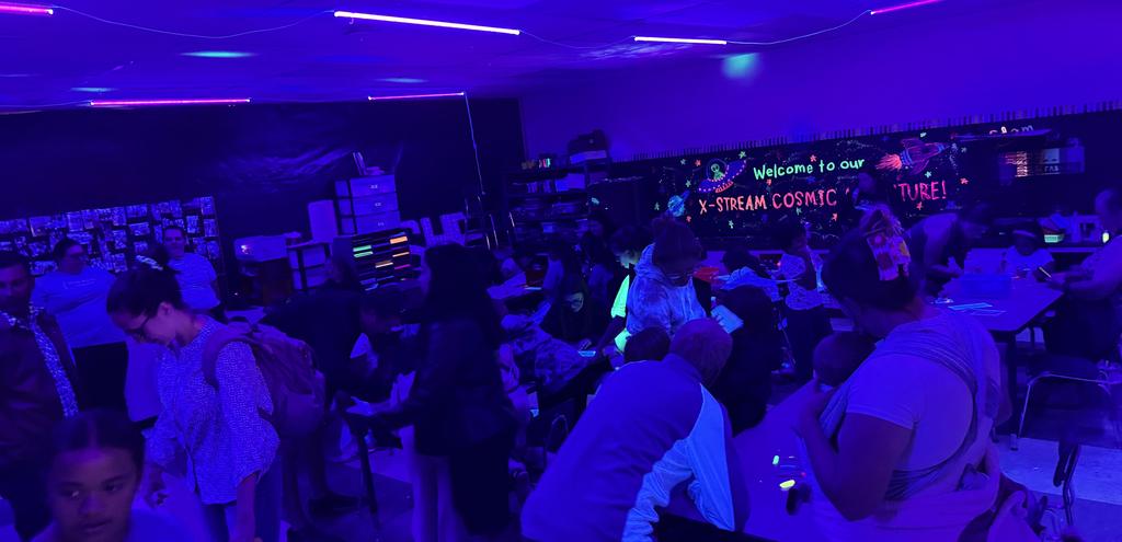 Glowing artwork and people enjoy STEM projects