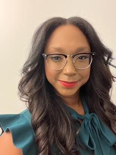 Crystal Haynes photo. Woman with long black hair and glasses smiling. 