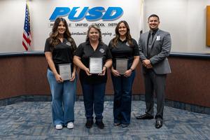 people posing in the governing board room
