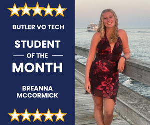 blond girl on a pier leaning on post next to water