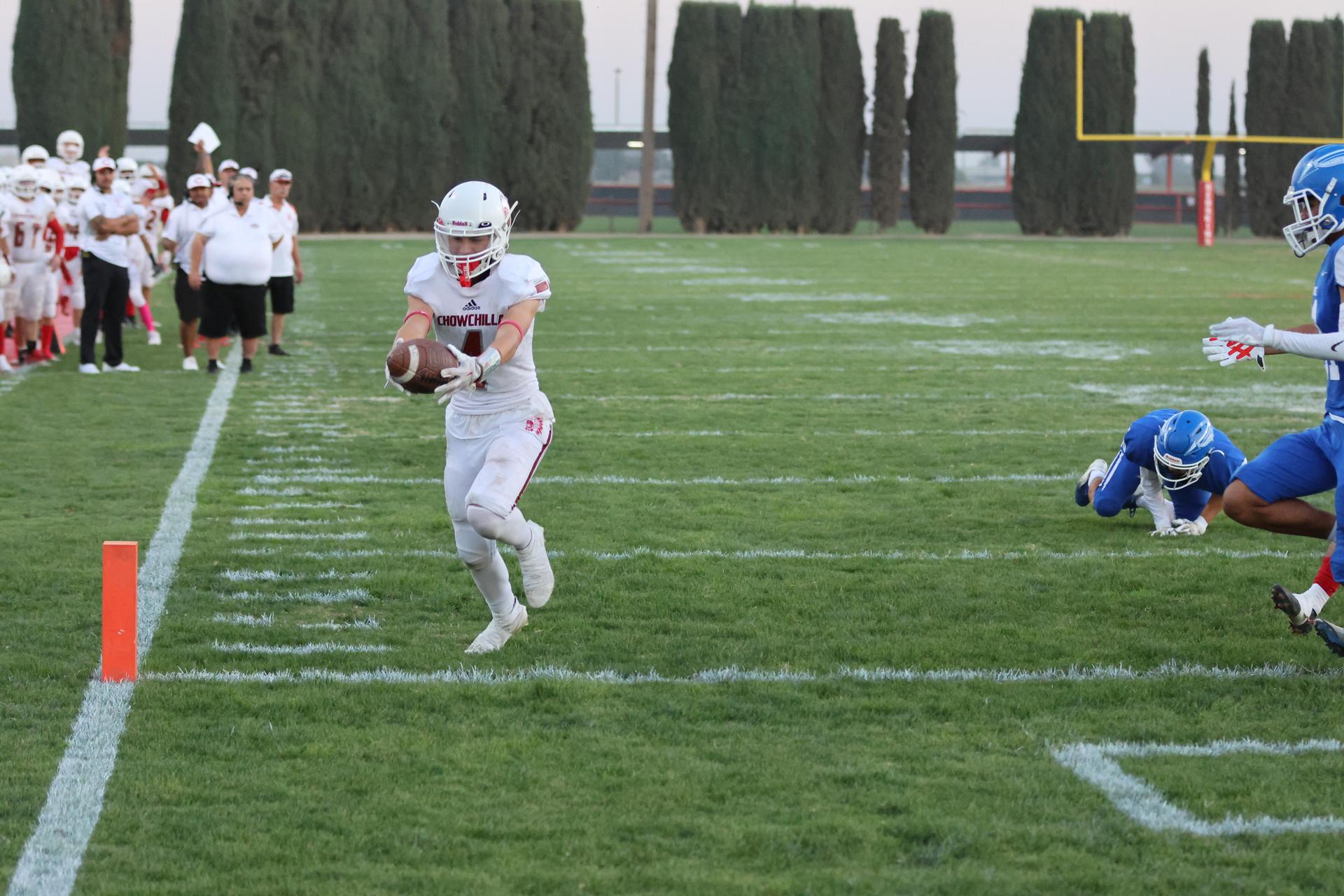 Junior Varsity football players in action against Caruthers