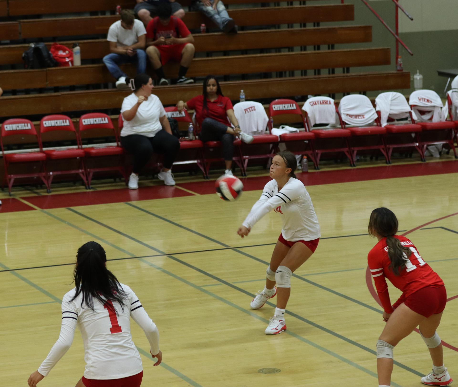 varsity volleyball players in action against liberty