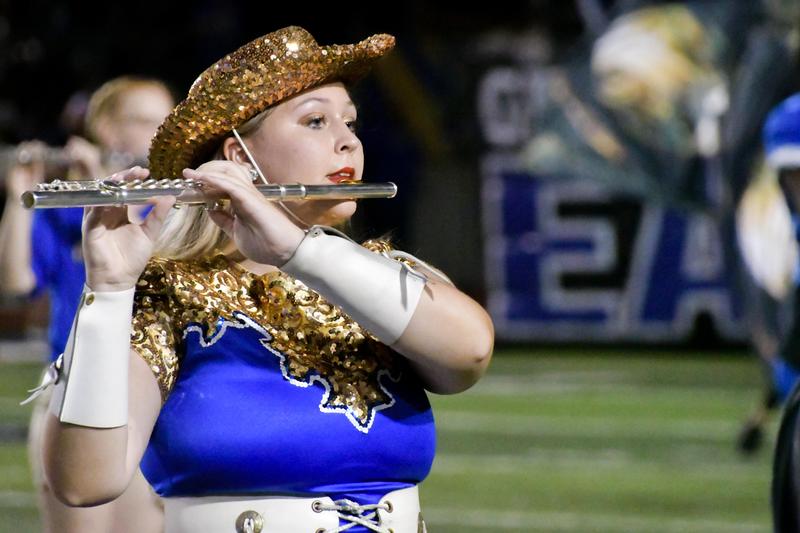 Girl in dance uniform playing flute