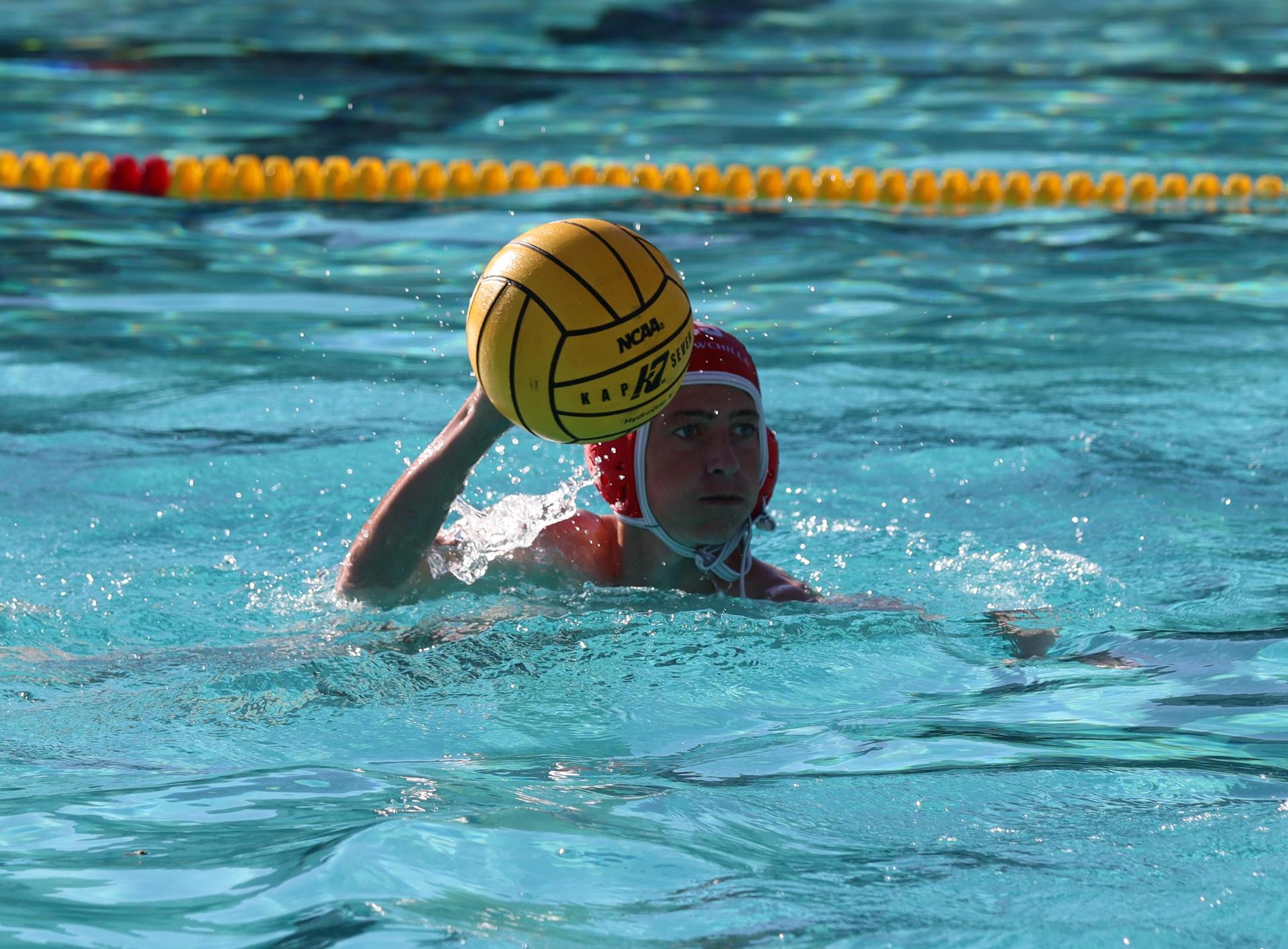 boys water polo players in action against hoover