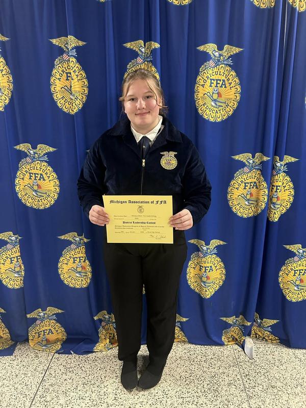 A student shows her certificate in the job interview contest.