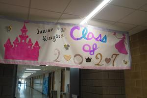 A class banner welcomes students down their hallway.