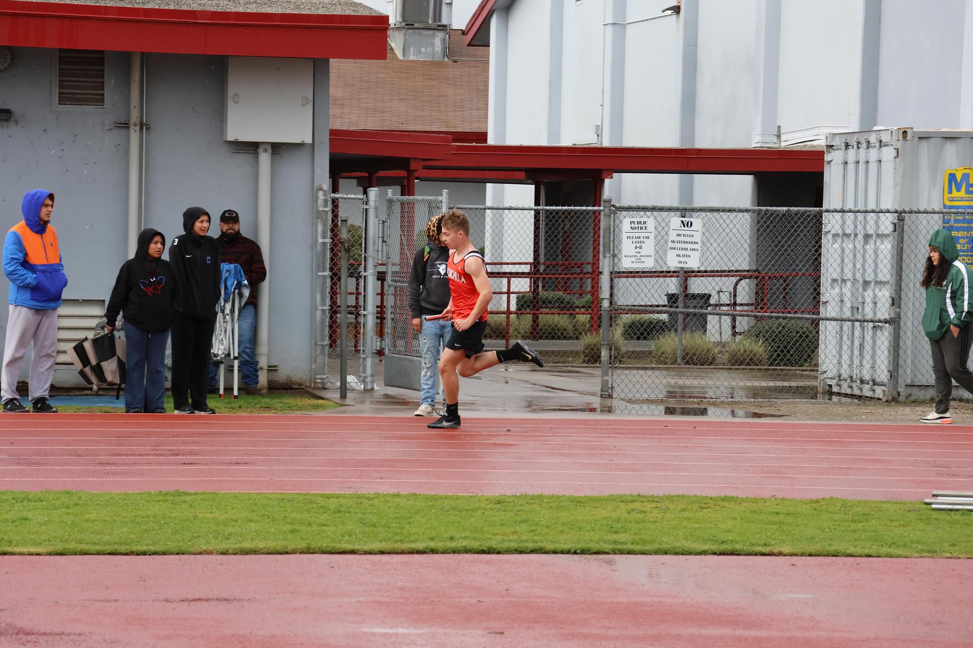 junior varsity boys running the four by 100 meter relay