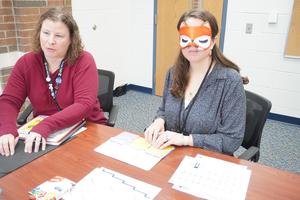 Page Elementary Principal Mrs. Forman uses her fingers to feel the lines on a paper.